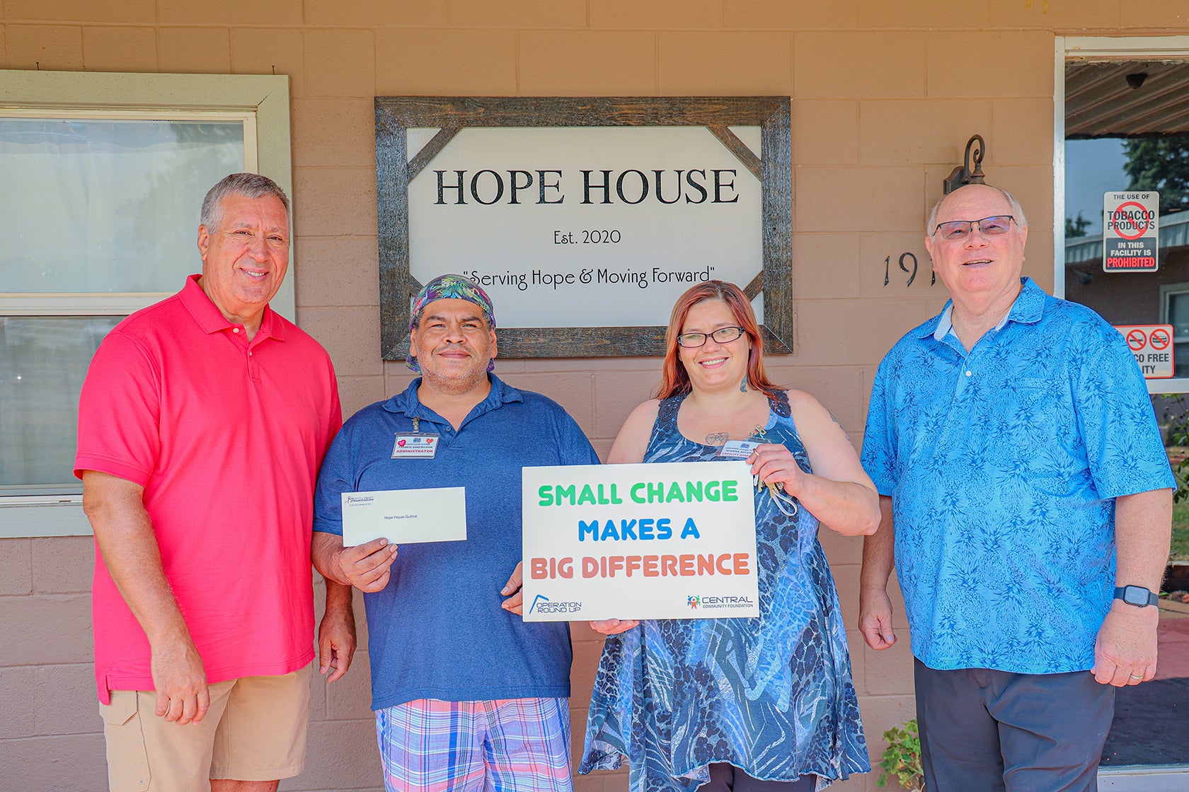 Steve Jones (far left), Central Community Foundation board member, and Sid Sperry (far right), Central Trustee, present Hope House’s Admin, Frankie Garcia-Leon (center left), and director of the women’s shelter, Shawna McLemore (center-right), with a Central Community Foundation grant.