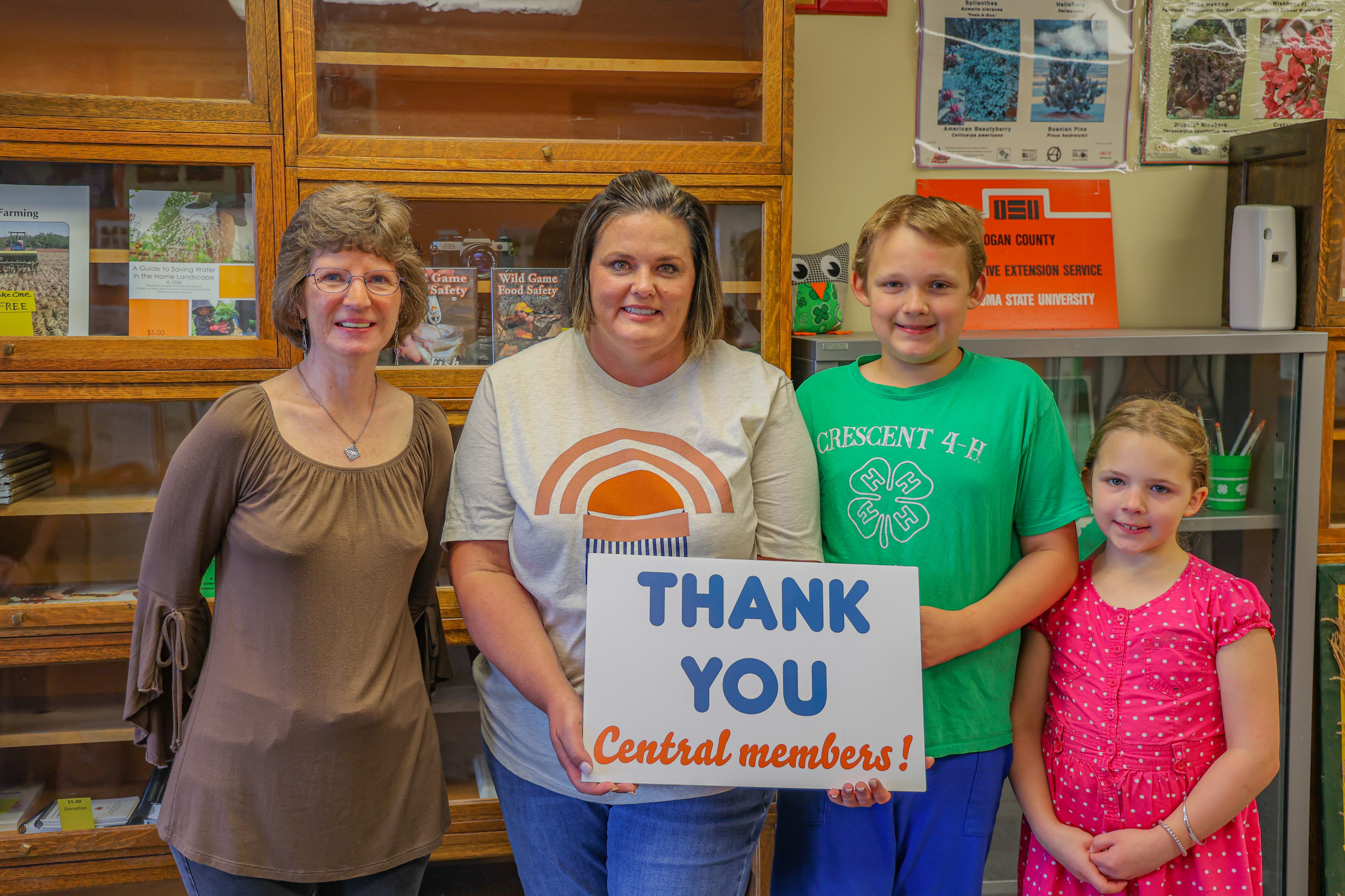 Central District four Trustee, Sid Sperry, presents 4-H Robotics Club leader Jennifer Dejonge; robotics club member Patrick Reinert, cloverbud member Jacqueline Reinert, and FCS/4-H Educator Dawn Andrew with a grant from the Central Community Foundation.