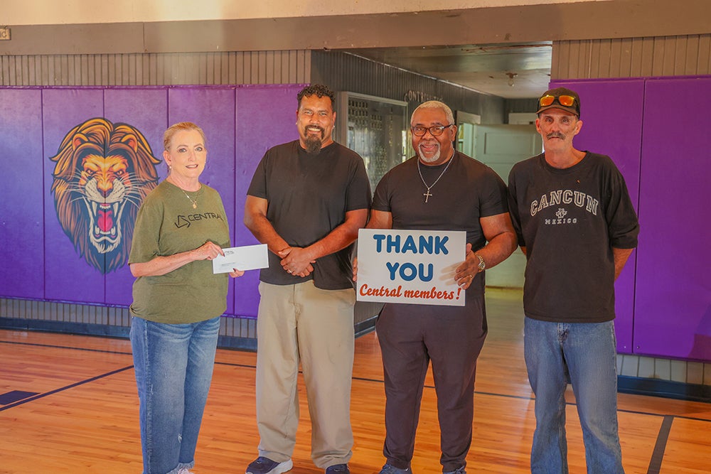 Central Community Foundation board member, Gretchen Harlow, presents Citizens for Improvement, Elizeo Rivera, Sergeant of Arms, David Burgess, president, and Scott Armsworthy, maintenance coordinator, with a grant from the Central Community Foundation.