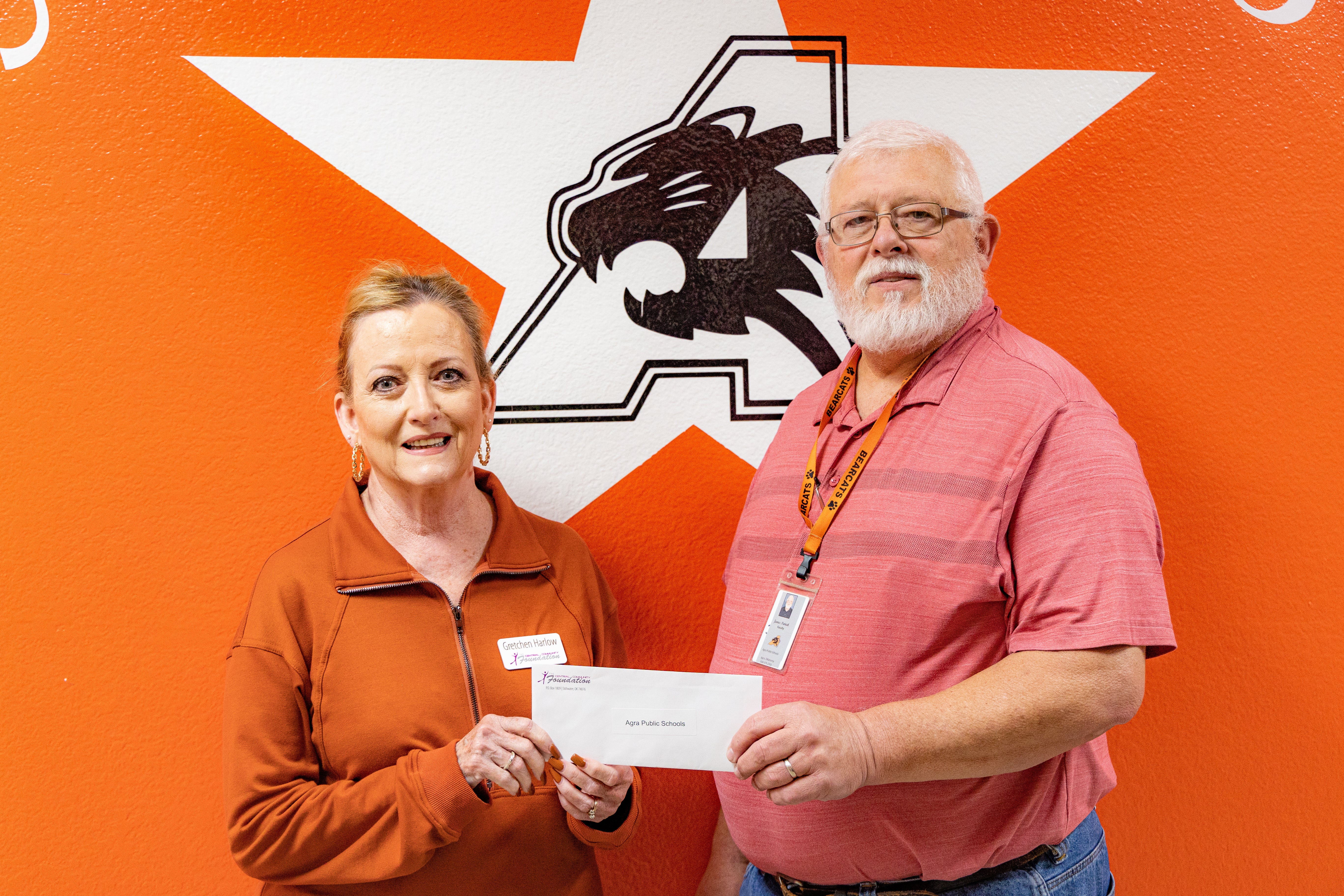 Central Community Foundation board member, Gretchen Harlow, presents Agra Public Schools teacher, James Patrick, with foundation grant.