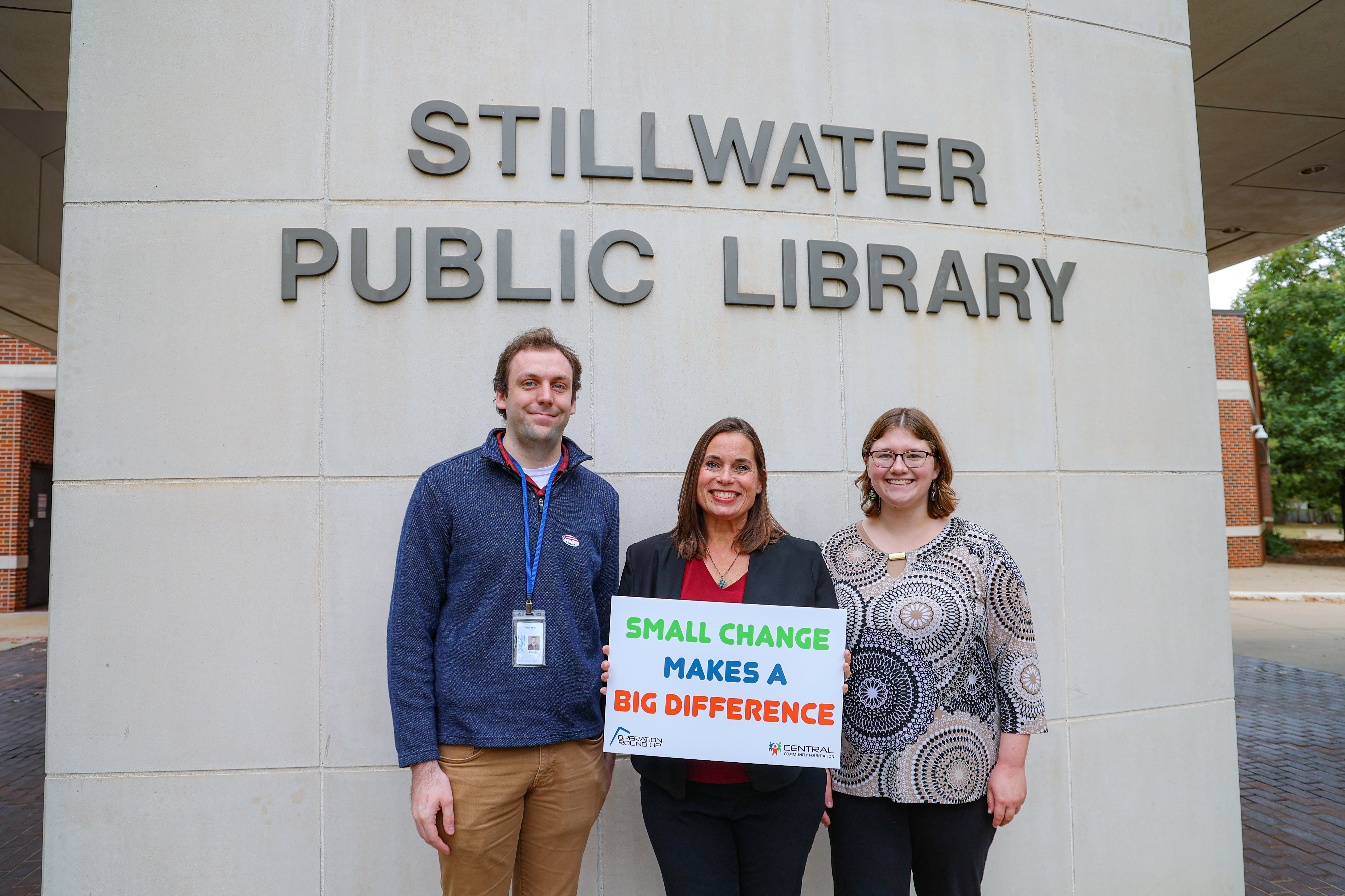 Librarian Jordan Stine, United Way of Payne County Director Ruth Cavins, and Library Aid Sarah Roer accept a Central Community Foundation check to help bring Imagination Library to Payne County. 