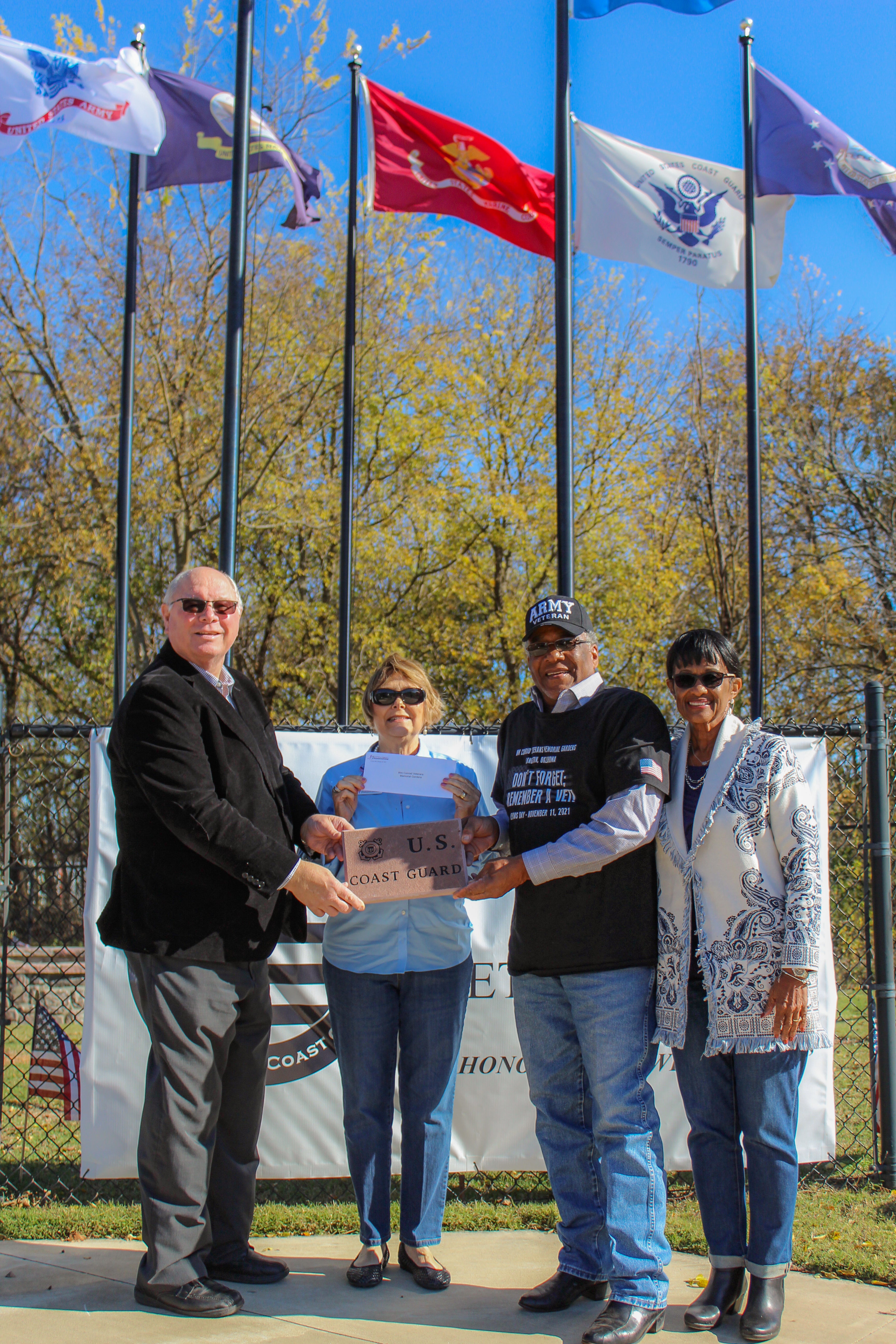 (From left to right) Central District 4 Trustee Sid Sperry and Central Community Foundation Board Member Janie Carey present a grant to Stewart Williams and Maeoma Williams from the WM Conrad Veterans Memorial Gardens.