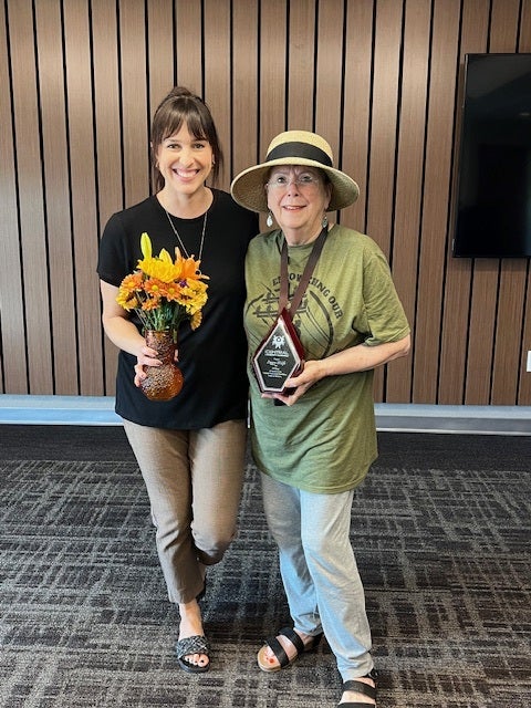 Central Community Foundation coordinator, Erin Talley, presents plaque and gifts to long-time board member, Peggy Wolfe.